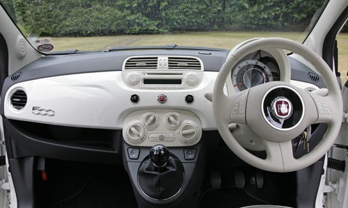 Interior view of Fiat 500 Lounge dashboard and steering wheel.