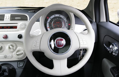 Fiat 500 Lounge interior showing steering wheel and dashboard.