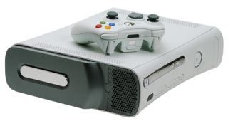 Xbox 360 console with wireless controller on top.