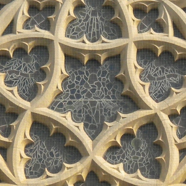 Intricate stone gothic window tracery design.