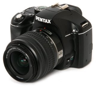 Pentax K-m DSLR camera with attached lens.
