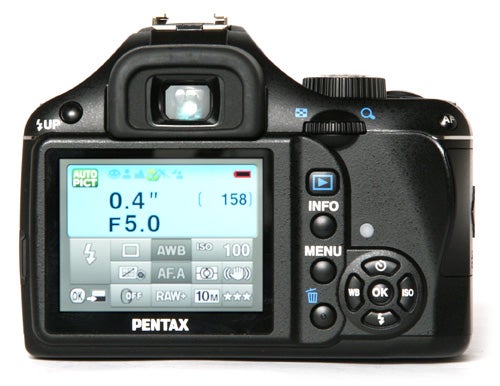 Pentax K-m DSLR camera rear view displaying settings screen.