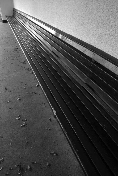 Black and white photo of a bench showing perspective lines.