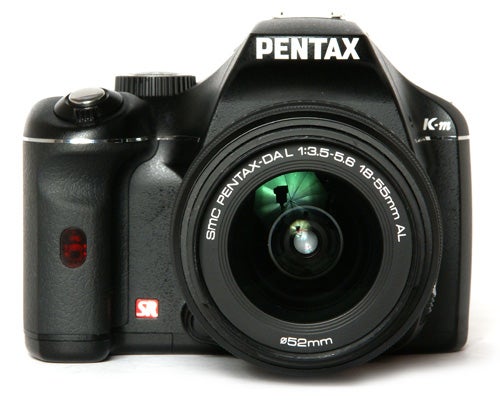Pentax K-m DSLR camera with lens on white background.