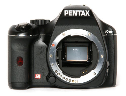 Pentax K-m DSLR camera rear view displaying settings screen.Pentax K-m DSLR camera body without lens.