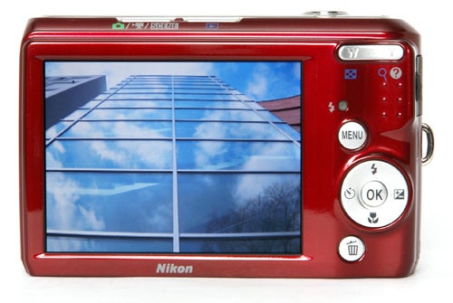 Nikon CoolPix L19 camera displaying skyscraper on screen.