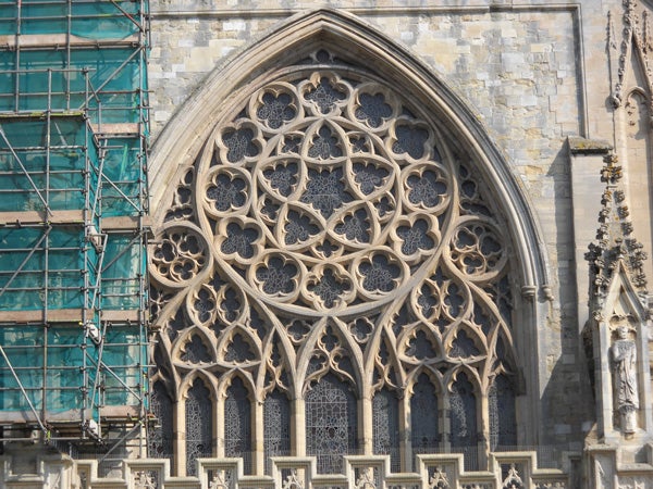 Detailed stonework of a gothic cathedral window.