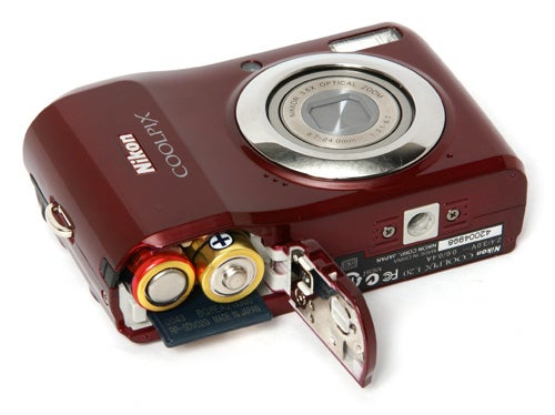 Nikon CoolPix L19 camera with battery compartment open.