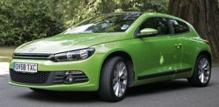 Green Volkswagen Scirocco GT 2.0l TSi parked outdoors.