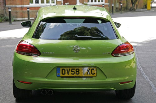 Green Volkswagen Scirocco GT from rear view on street