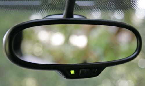 Rearview mirror with green light indicator inside Volkswagen Scirocco.