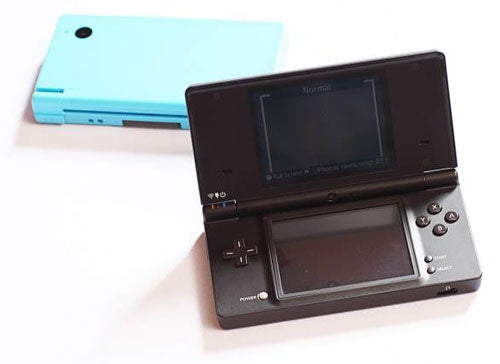 Black Nintendo DSi open next to a blue DSi closed.