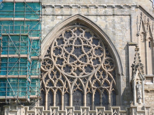 Detailed stonework on cathedral with scaffolding on the left