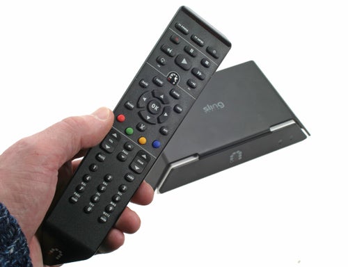 Hand holding SlingMedia SlingCatcher remote with device in background.