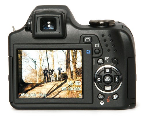 Olympus SP-590UZ camera displaying a photo on its screen.