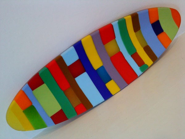 Colorful abstract surfboard-shaped artwork on white background.