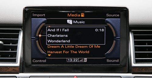 Audi A8 infotainment system display with music playlist.