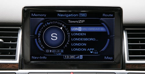 Audi A8 navigation system display showing map and menu options.