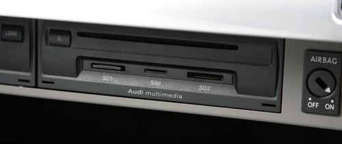 Audi A8 multimedia interface with SD card slots and airbag control.Audi A8 CD changer control buttons on dashboard