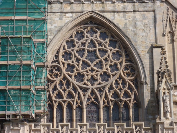 Detailed architecture of gothic church window with scaffolding.