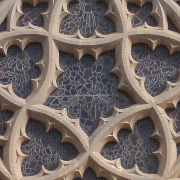 Close-up of intricate stone lattice work with a background.