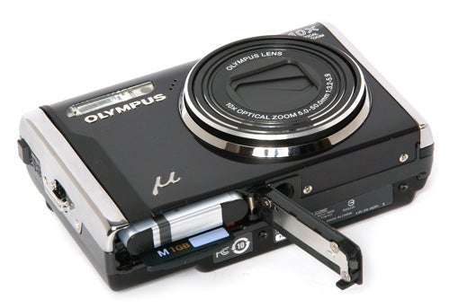 Olympus mju 9000 camera with open battery compartment.