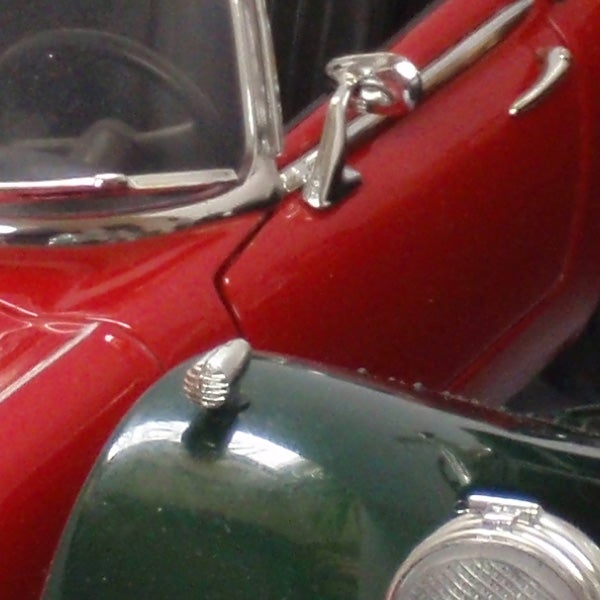 Close-up of a vintage red and green model car