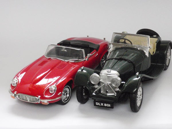 Two classic model cars on a white background.
