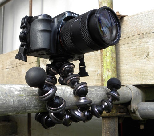 Joby Gorillapod holding a camera attached to a metal pole