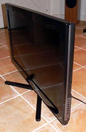 JVC LT-32DR1BJ 32-inch LCD TV on a tiled floor.