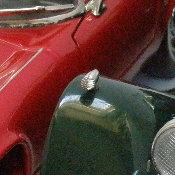 Close-up of vintage car details with a red and green body
