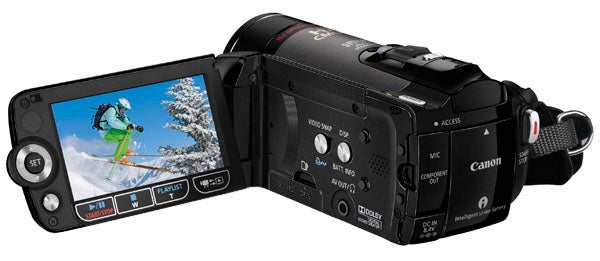 Canon Legria HF20 camcorder with flip-out screen displaying video.