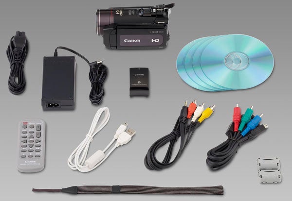 Canon Legria HF20 camcorder with accessories and cables.