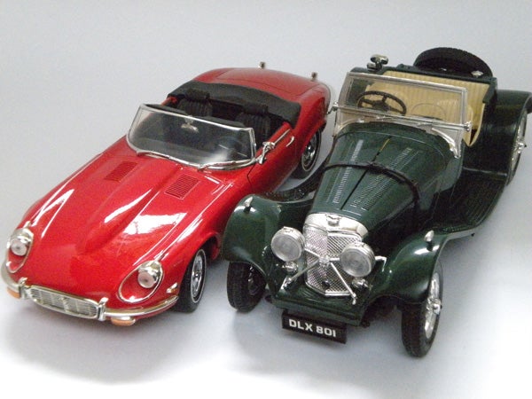 Two model cars on a white background
