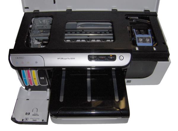 HP Officejet Pro 8000 printer with open cover showing ink cartridges.