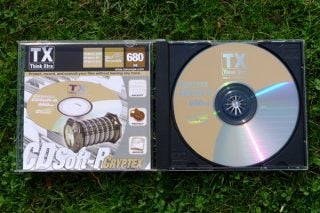 Think Xtra CDSoft-R Cryptex software CD and packaging on grass.