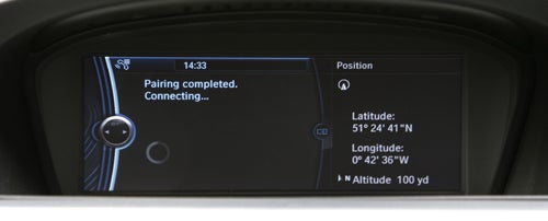 BMW ConnectedDrive screen showing pairing completed message and GPS coordinates.