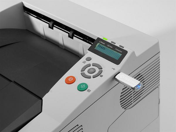 Kyocera Mita FS-1350DN printer with control panel and USB stick.