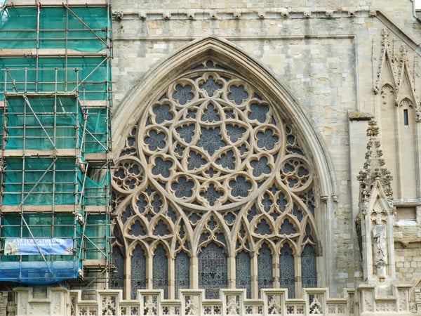 Detailed church window with scaffolding on the left side.