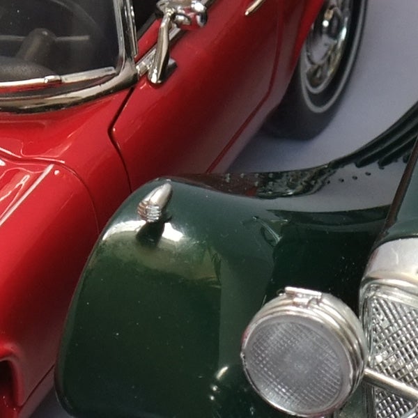Close-up photo of a red and green model car.