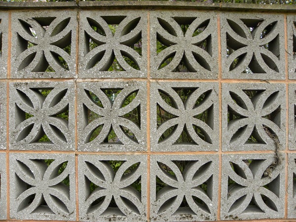 Decorative concrete block wall with symmetrical patterns.