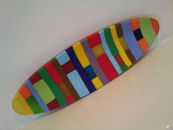 Colorful surfboard-shaped object with a pattern of rectangles.