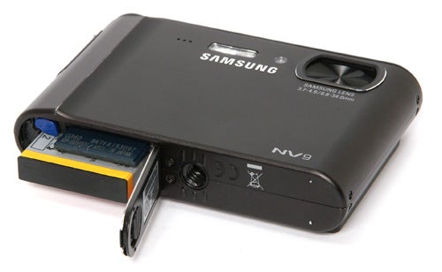 Samsung NV9 camera with open battery compartment.