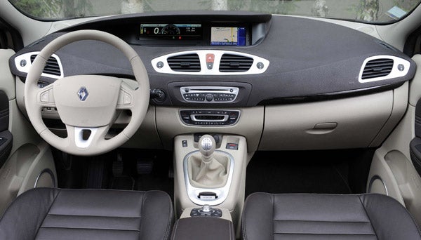 Interior dashboard view of Renault Grand Scenic showing steering and controls.