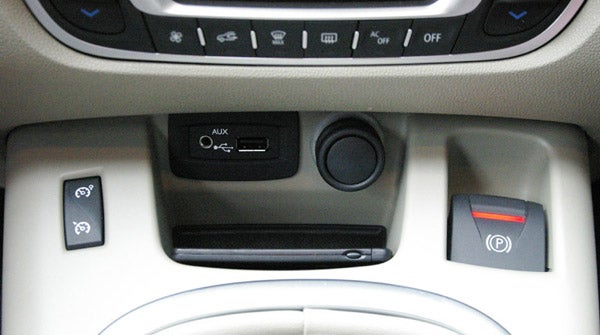 Center console of a Renault Grand Scenic with controls and AUX port.