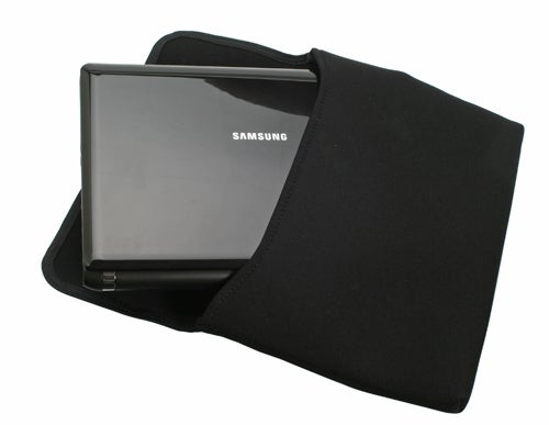 Samsung N110 netbook partially inserted into a black sleeve.