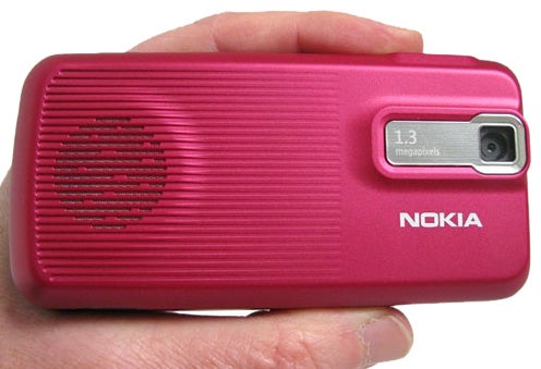 Hand holding a pink Nokia 7100 Supernova phone.