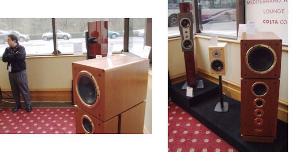 Speaker system displayed at electronic showroom with bystander.