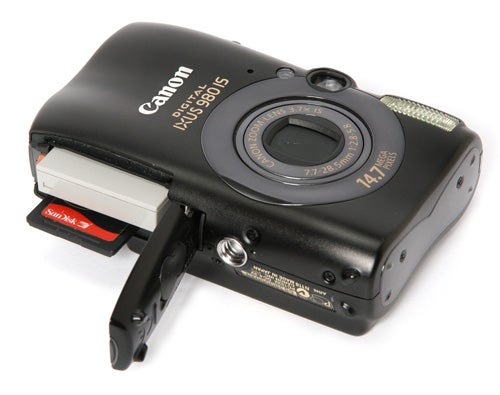Canon IXUS 980 IS camera with battery compartment open.