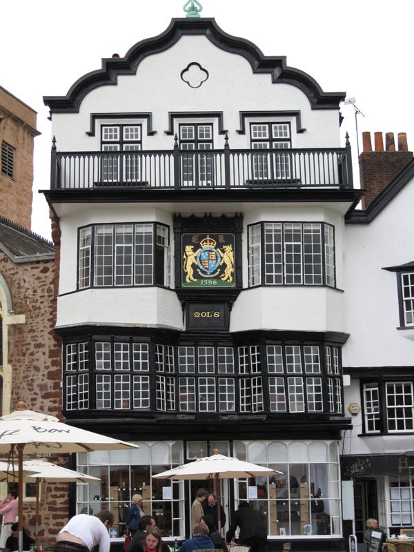 Photo of a half-timbered historical building with a crest.